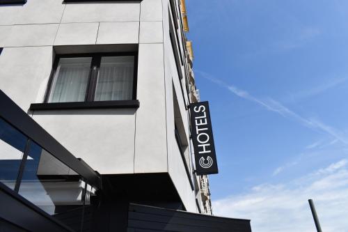 a building with a sign on the side of it at C-Hotels Burlington in Ostend