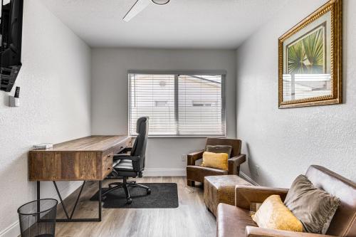 an office with a desk and a chair and a couch at Cocoa Beach Home with Private Pool about half Mi to Beach in Cocoa Beach