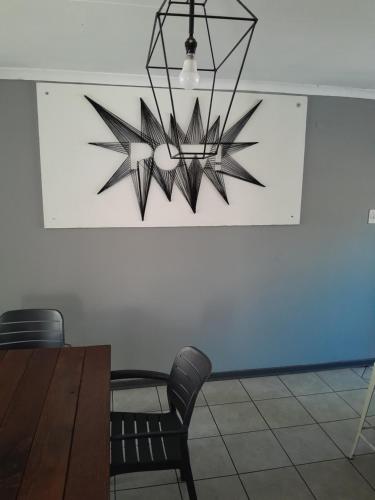 a chandelier hanging in a dining room with a table at Tortilla no 3 in Bloemfontein