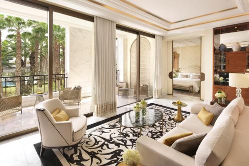 a living room with white furniture and large windows at The Ritz-Carlton Rabat, Dar Es Salam in Rabat