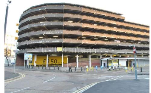 an empty parking lot in front of a building at Leicester City Center - TBH in Leicester