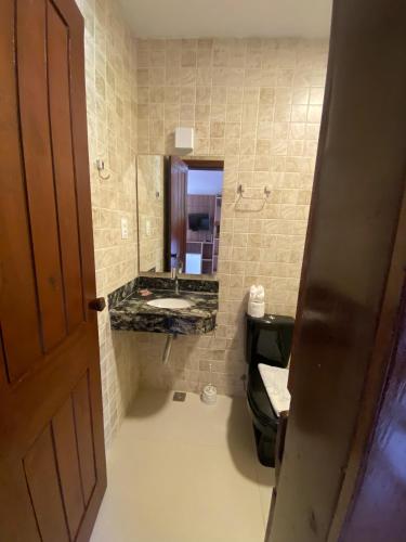 a bathroom with a sink and a mirror at Pousada Porto da Barra in Barra Grande