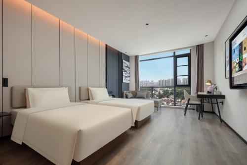 Postel nebo postele na pokoji v ubytování Atour Hotel Jiangmen Huayin Plaza