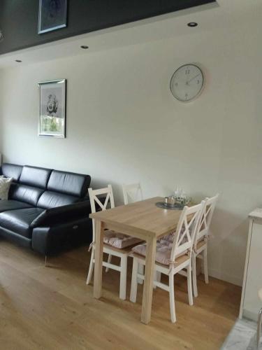 a living room with a table and a couch at Apartament na Kolarskiej in Ostrów Mazowiecka