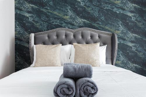 a bedroom with a bed with towels on it at The Echelon Sukhumvit 11 by LeFoyer in Bangkok