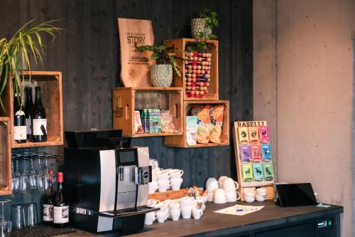 a coffee shop with a counter with a coffee maker at Story Thusis in Thusis