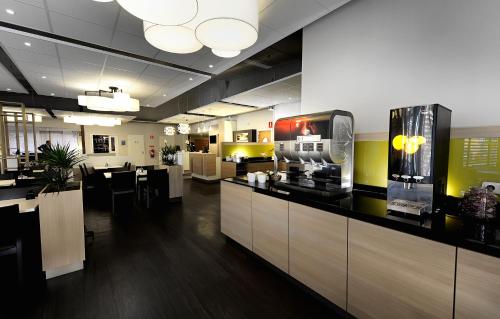 a restaurant with a bar with a tv on the counter at Good Morning Kista in Stockholm