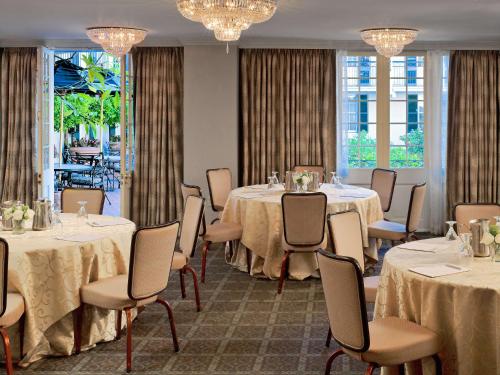 a conference room with tables and chairs and chandeliers at The Royal Sonesta New Orleans in New Orleans