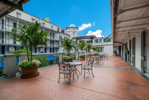 a courtyard with tables and chairs in a building at The Royal Sonesta New Orleans in New Orleans
