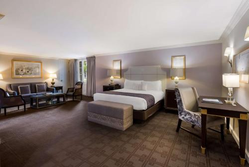 a hotel room with a bed and a desk at The Royal Sonesta New Orleans in New Orleans