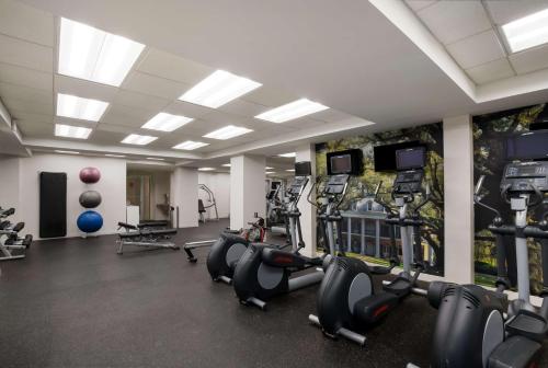 a gym with several treadmills and cardio machines at The Royal Sonesta New Orleans in New Orleans