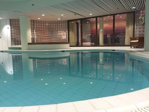 a large swimming pool in a building at Lapland Hotels Oulu in Oulu
