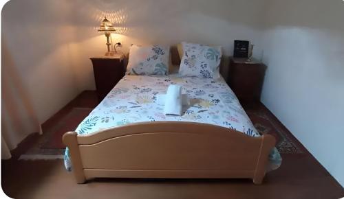 a bedroom with a bed with a candle on it at Chambres d'amis Petit déjeuner offert in Vialas