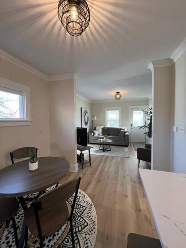 a living room with a table and a couch at Cedar Street Retreat - Heart of Aksarben! in Omaha