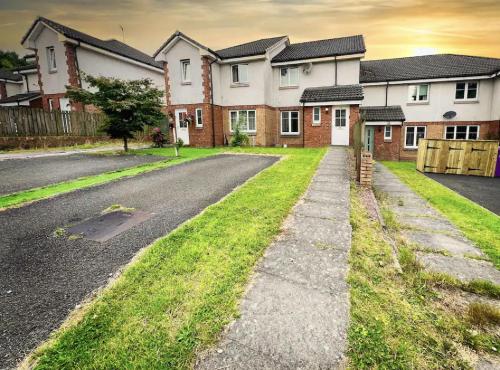an empty street in front of a house at Glasgow Central - Entire house - Free Parking , Free super fast Wifi , Private garden & Parking security in Govan