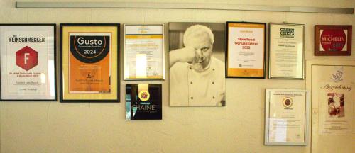 a wall with a bunch of posters on it at Gasthof zum Hirsch in Neukirch