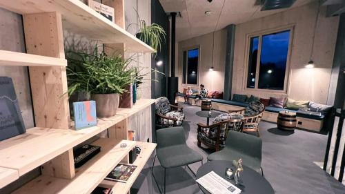 a salon with chairs and tables and a waiting room at Story Thusis in Thusis