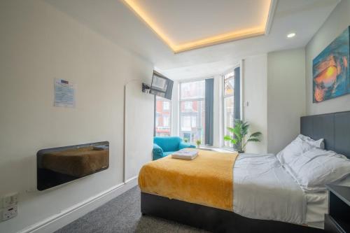 a bedroom with a king sized bed and a tv at Driftwood Rooms in Blackpool