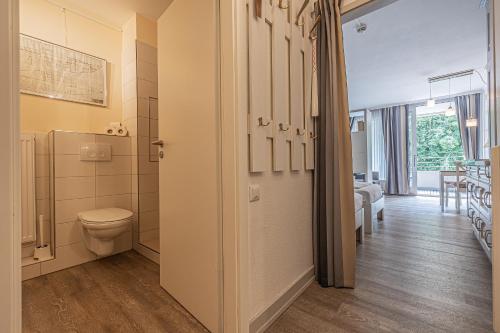 a bathroom with a toilet and a walk in shower at fewo1846 Intermar - Gruene Insel - Studioapartment mit Balkon und Blick ins Grüne in Glücksburg