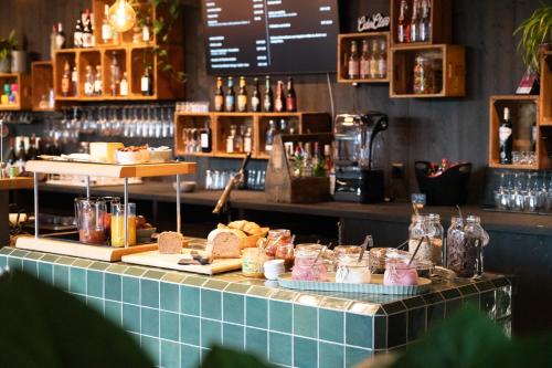 a bar with a counter with food on it at Story Thusis in Thusis