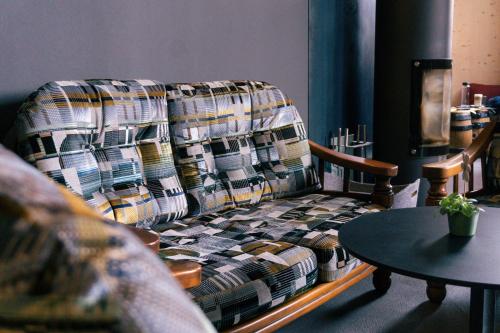 a couch in a living room with a table at Story Thusis in Thusis