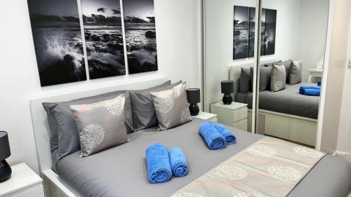 - une chambre avec un lit doté d'oreillers et de miroirs bleus dans l'établissement 23 Innes Street Apartment, à Inverness