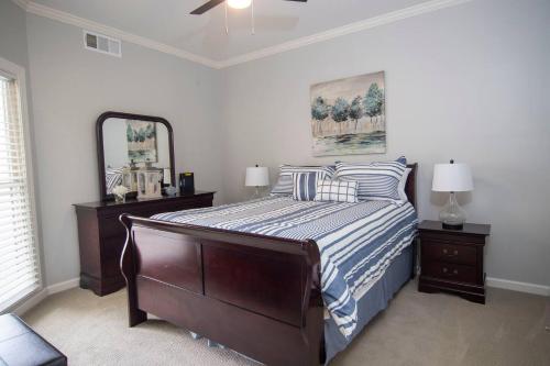 a bedroom with a bed with a mirror and a dresser at Ground Floor Golf Course Condo in Oxford