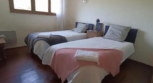 two beds sitting next to each other in a room at Chambres d'amis Petit déjeuner offert in Vialas