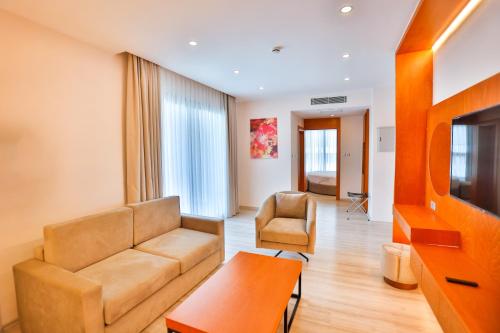 a living room with a couch and a table at Caddem Inn Hotel in Mağusa