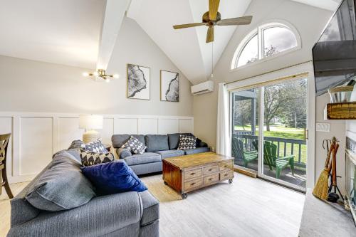 a living room with a couch and a table at Ellicottville Townhome Near Holiday Valley Resort! in Ellicottville