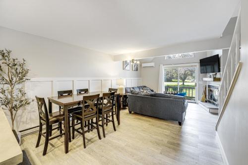 a kitchen and living room with a table and a couch at Ellicottville Townhome Near Holiday Valley Resort! in Ellicottville