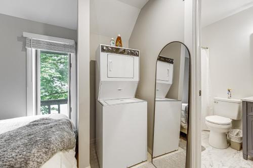 a bedroom with a white refrigerator and a toilet at Ellicottville Townhome Near Holiday Valley Resort! in Ellicottville