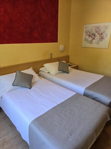 two beds sitting next to each other in a room at Mokinba Hotels Sant'Ambroeus in Milan