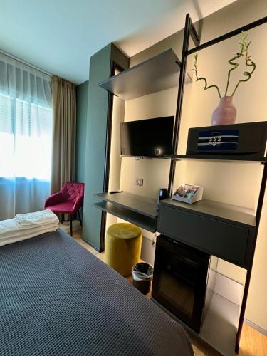 a hotel room with a bed and a book shelf at Levelup in Treviso