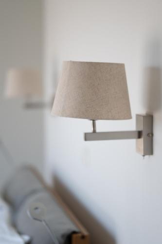 a lamp attached to a wall with ainylinylinylinylinylinylinylinyl at Villa & Stone House with Pool, 10 Mins to Skala Eressos Beach in Eresos