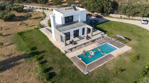 an aerial view of a house with a swimming pool at Villa & Stone House with Pool, 10 Mins to Skala Eressos Beach in Eresos