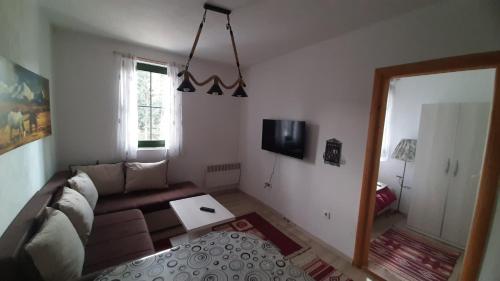 a living room with a couch and a table at Apartments Durmitor in Žabljak