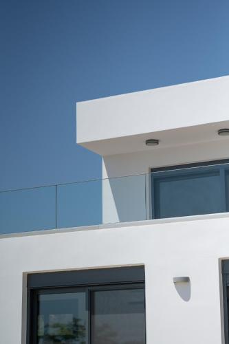 a close up of a white building with a blue light at Villa & Stone House with Pool, 10 Mins to Skala Eressos Beach in Eresos