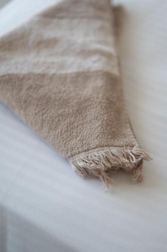a close up of a blanket on a bed at Villa & Stone House with Pool, 10 Mins to Skala Eressos Beach in Eresos