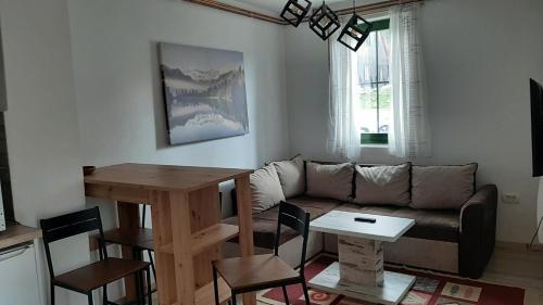 a living room with a couch and a table at Apartments Durmitor in Žabljak