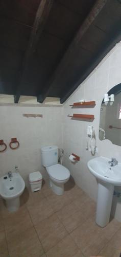 a bathroom with a toilet and a sink at Casa Giuliana in Charco del Pino