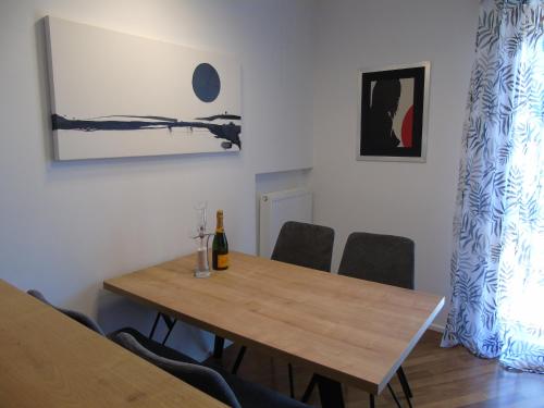 a dining room with a wooden table and chairs at Appartamento Nicole in Ravascletto