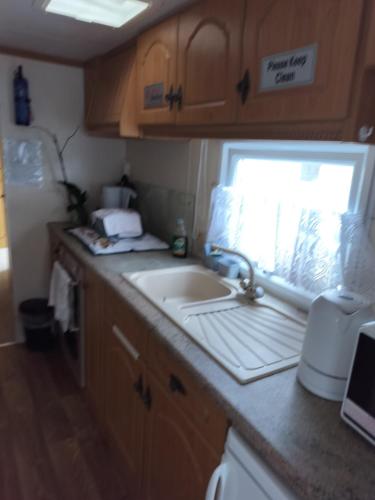 a kitchen with a sink and a window at Ingoldmells Skegness holiday break at coral beach by Hannah in Lincolnshire