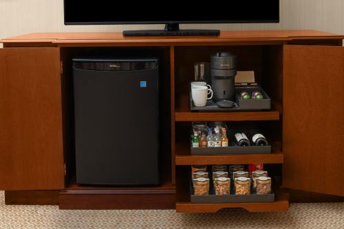 a small black refrigerator in a entertainment center at Capital Hotel in Little Rock