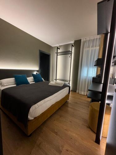 a bedroom with a large bed with blue pillows at Levelup in Treviso