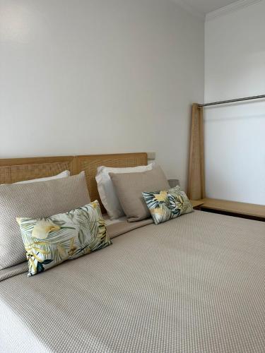 a bedroom with a bed with pillows on it at Guest House MJ in Póvoa de Varzim