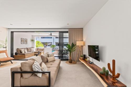 a living room with a couch and a tv at Zon&zo Luxurious Apartment in Jan Thiel in Jan Thiel