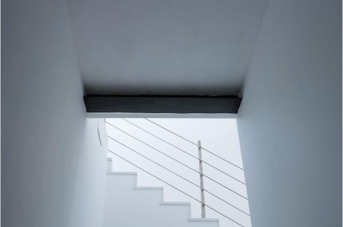 a staircase in a white building with a black ledge at Vittoria Design Hotel di Luce Hotels in Siena