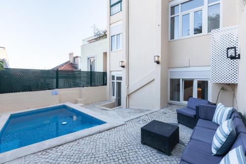 a patio with a swimming pool next to a building at FLH Graça Charming Duplex with Small Pool in Lisbon