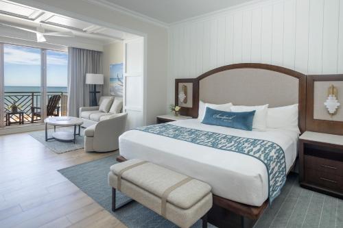 a hotel room with a bed and a balcony at Sandpearl Resort Private Beach in Clearwater Beach